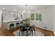 Modern kitchen and dining area featuring white cabinets, stainless steel appliances, and hardwood floors at 800 Breckinridge Sw Rd, Marietta, GA 30064