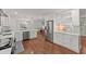 Open kitchen with white cabinets, stainless steel appliances, and an island with seating at 800 Breckinridge Sw Rd, Marietta, GA 30064