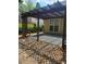 Cozy backyard patio with a pergola and a swing, creating a relaxing outdoor living space at 1150 Hillary Ln, Lawrenceville, GA 30043
