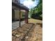 Backyard patio with concrete flooring, wooden pergola, and irregular stone walkway at 1150 Hillary Ln, Lawrenceville, GA 30043