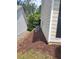 Side of home with mulched garden bed at 1150 Hillary Ln, Lawrenceville, GA 30043