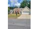 Charming single-Gathering home with a well-maintained lawn and two-car garage in a suburban neighborhood at 1150 Hillary Ln, Lawrenceville, GA 30043