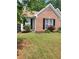 Charming home with a well-manicured lawn, blooming flowers, and brick accents at 1150 Hillary Ln, Lawrenceville, GA 30043
