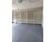 Spacious garage with painted floors and built-in white shelving along the back wall at 1150 Hillary Ln, Lawrenceville, GA 30043