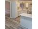 Well-lit eat-in kitchen with white cabinetry, quartz countertops, and laminate wood-look flooring at 1150 Hillary Ln, Lawrenceville, GA 30043