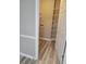 Convenient laundry area with shelving, white cabinets, and wood-look laminate flooring at 1150 Hillary Ln, Lawrenceville, GA 30043