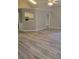 Spacious living room with sleek floors, ceiling fan, and an open layout leading to the kitchen at 1150 Hillary Ln, Lawrenceville, GA 30043