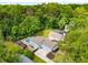 Aerial view of the property showcasing the pool, hot tub, mature trees, and landscaped yard at 1928 Main Nw St, Atlanta, GA 30318