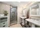 Bright bathroom featuring double sink vanity, glass enclosed shower and tile floors at 1928 Main Nw St, Atlanta, GA 30318