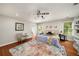 Bright bedroom featuring hardwood floors, ceiling fan, and closet access at 1928 Main Nw St, Atlanta, GA 30318