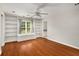 Spacious bedroom with hardwood floors, built-in shelving, and a ceiling fan for added comfort at 1928 Main Nw St, Atlanta, GA 30318