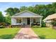 Charming single-story home featuring a quaint front porch, lush lawn, and inviting curb appeal with well-maintained landscaping at 1928 Main Nw St, Atlanta, GA 30318