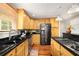 Well-lit kitchen with stainless steel appliances, granite countertops, and light wood cabinetry at 1928 Main Nw St, Atlanta, GA 30318