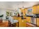 Kitchen with stainless appliances, breakfast bar, and warm wood cabinets at 1928 Main Nw St, Atlanta, GA 30318