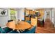 Kitchen and dining area featuring wooden cabinets, stainless appliances, and modern lighting at 1928 Main Nw St, Atlanta, GA 30318