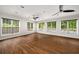 Bright living room with hardwood floors and large windows overlooking outdoor pool and lush greenery at 1928 Main Nw St, Atlanta, GA 30318