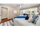 Bright main bedroom featuring hardwood floors, ceiling fan, and access to sunroom at 1928 Main Nw St, Atlanta, GA 30318