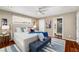 Bright main bedroom featuring hardwood floors, ceiling fan, and access to bathroom at 1928 Main Nw St, Atlanta, GA 30318