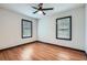 Bright bedroom featuring hardwood floors, ceiling fan and natural light from windows at 2091 Parker Ranch Se Rd, Atlanta, GA 30316