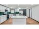 Open kitchen with island, white cabinets, stainless steel appliances, and unique green backsplash at 2091 Parker Ranch Se Rd, Atlanta, GA 30316