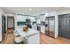 Spacious kitchen boasts white cabinets, green backsplash, island with seating, and stainless-steel appliances at 2091 Parker Ranch Se Rd, Atlanta, GA 30316