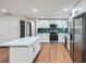 Modern kitchen with an island, stainless-steel appliances, white cabinets, and stunning green backsplash at 2091 Parker Ranch Se Rd, Atlanta, GA 30316