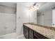 Spacious bathroom with a granite countertop vanity and a shower-tub combo at 27 Lakes Edge Se Dr, Smyrna, GA 30080