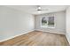 Bedroom featuring sleek flooring, ceiling fan, and a window with outdoor views at 27 Lakes Edge Se Dr, Smyrna, GA 30080