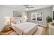 Bright bedroom with white bedding, modern decor, ceiling fan, and large windows at 27 Lakes Edge Se Dr, Smyrna, GA 30080
