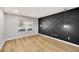 Open-concept living room with modern flooring, black accent wall, and a large window at 27 Lakes Edge Se Dr, Smyrna, GA 30080