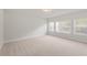 Spacious bedroom with neutral carpet, recessed lighting, and large windows allowing ample natural light at 3301 Lions Ruby Ln, Atlanta, GA 30349