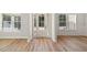 Bright entryway with wood-look flooring, white walls, and natural light from two windows at 3301 Lions Ruby Ln, Atlanta, GA 30349