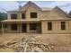 The new home's exterior shows the wood frame structure with window placement at 3301 Lions Ruby Ln, Atlanta, GA 30349
