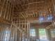 View of the interior construction of a two-story home with framing for a stairway and windows at 3301 Lions Ruby Ln, Atlanta, GA 30349