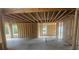 View of the interior construction of a large room with several framed-in window openings at 3301 Lions Ruby Ln, Atlanta, GA 30349
