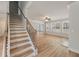 Bright living room with wood floors, white walls, ceiling fan, and staircase at 3301 Lions Ruby Ln, Atlanta, GA 30349