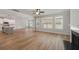 Expansive living space featuring a fireplace, hardwood floors, kitchen, and large windows at 3301 Lions Ruby Ln, Atlanta, GA 30349