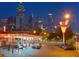 Illuminated night view of Varsity restaurant with the city skyline in the background at 3301 Lions Ruby Ln, Atlanta, GA 30349