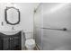 Bathroom featuring a vanity with framed mirror and a glass door shower enclosure at 557 Lawton Sw St, Atlanta, GA 30310