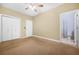 Bedroom with neutral walls, carpet flooring, double closets, and an ensuite bathroom at 557 Lawton Sw St, Atlanta, GA 30310