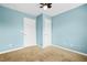 Cozy bedroom with neutral carpet, light fixture and two closets at 557 Lawton Sw St, Atlanta, GA 30310
