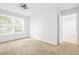 Bright bedroom featuring natural light, carpet floors and an ensuite bathroom at 557 Lawton Sw St, Atlanta, GA 30310