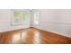 Inviting dining room with hardwood floors, white walls, bright windows, and classic molding at 557 Lawton Sw St, Atlanta, GA 30310