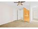 Hallway featuring carpet flooring with an orange accent wall leading to the bathroom at 557 Lawton Sw St, Atlanta, GA 30310