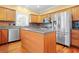Kitchen featuring stainless appliances, hardwood floors, and center island at 557 Lawton Sw St, Atlanta, GA 30310