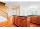 Kitchen featuring hardwood floors, center island, staircase, and open floorplan at 557 Lawton Sw St, Atlanta, GA 30310