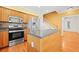 Kitchen featuring stainless steel appliances, hardwood floors, and island at 557 Lawton Sw St, Atlanta, GA 30310
