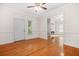 Spacious living room with hardwood floors, fireplace, large window, and white trim and access to hallway at 557 Lawton Sw St, Atlanta, GA 30310