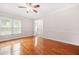 Sun-filled living room featuring hardwood floors, large windows, and easy access to the entrance and hallways at 557 Lawton Sw St, Atlanta, GA 30310
