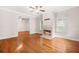 Bright living room featuring hardwood floors, a fireplace, large windows, and access to other rooms at 557 Lawton Sw St, Atlanta, GA 30310
